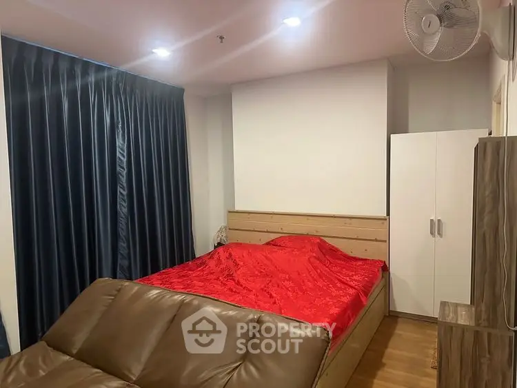 Cozy bedroom with red bedding and modern furniture