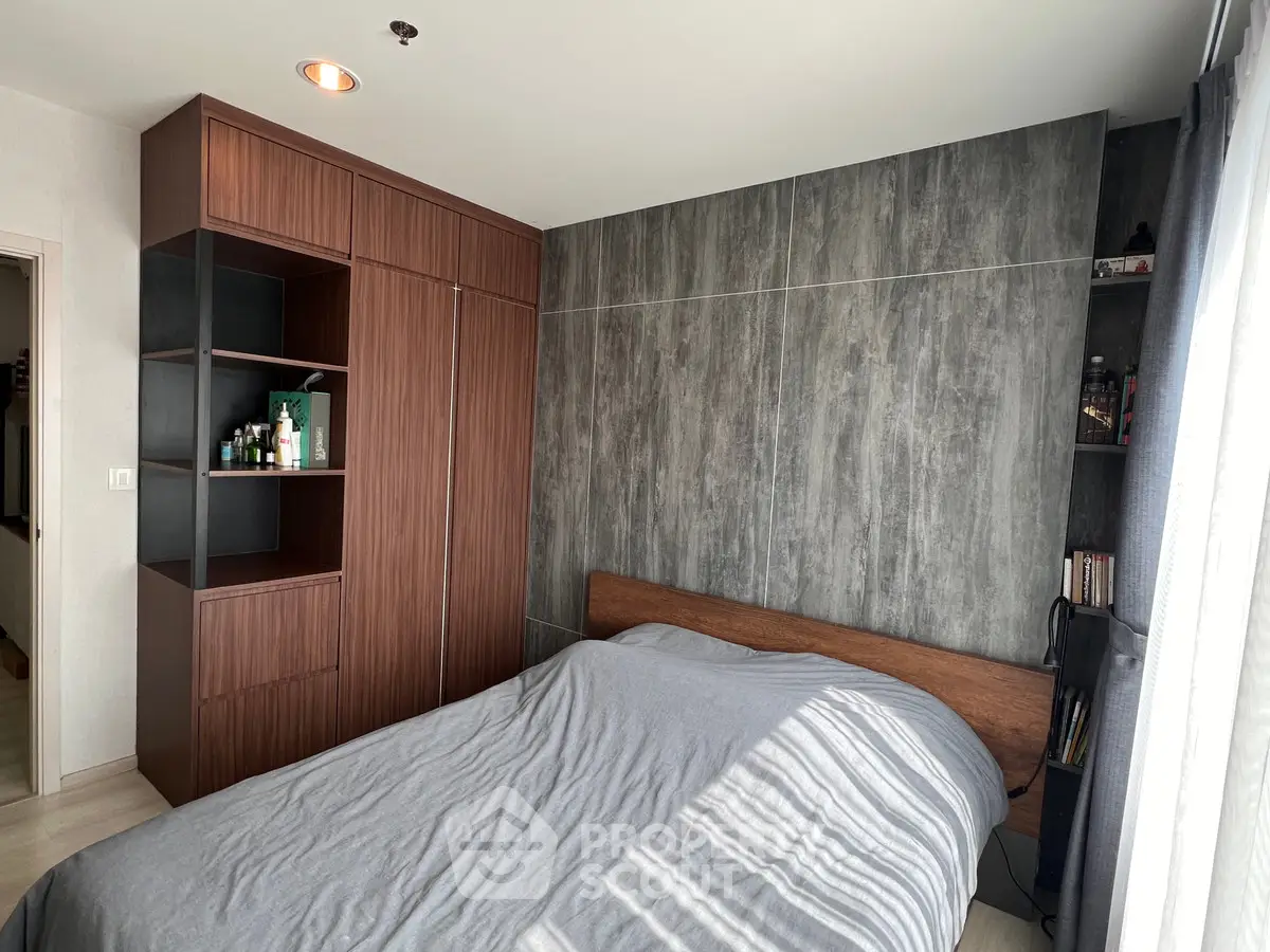 Modern bedroom with stylish wooden wardrobe and cozy bed