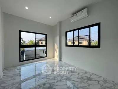 Spacious room with marble flooring and large windows offering natural light and modern air conditioning.