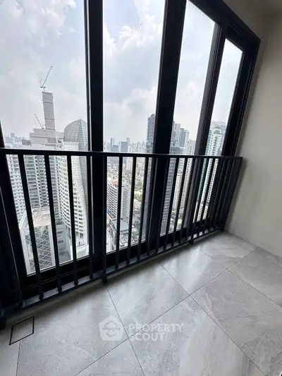 Stunning high-rise balcony with panoramic city views and sleek modern design.