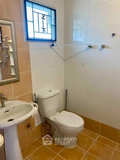 Modern bathroom with sleek fixtures and tiled walls, perfect for a contemporary home.