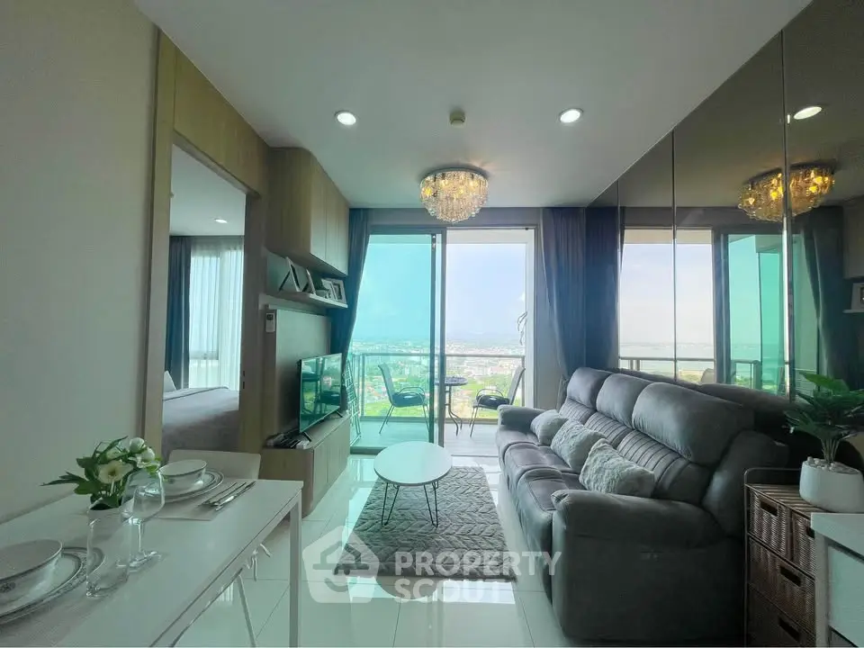 Modern living room with balcony and stunning city view, featuring elegant decor and ample natural light.