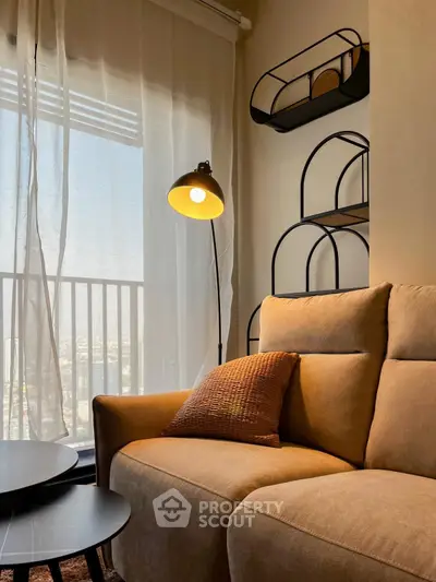 Cozy living room with modern decor and city view from balcony.