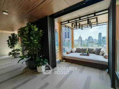 Luxurious balcony with stunning city view and elegant seating area in modern high-rise apartment.