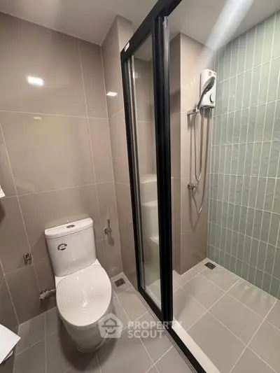Modern bathroom with sleek shower and toilet in contemporary apartment