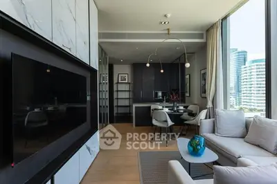 Modern living room with large TV, elegant furniture, and city view through floor-to-ceiling windows.