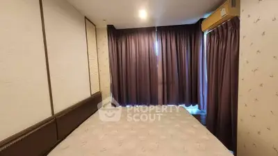 Cozy bedroom with elegant curtains and soft lighting, perfect for relaxation.