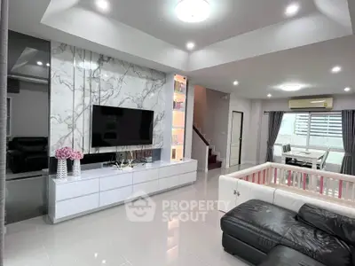 Modern living room with marble accent wall and sleek furniture