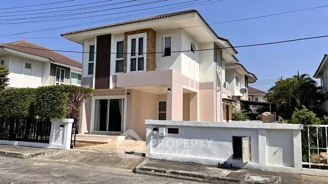 Modern two-story house with stylish facade and driveway in suburban neighborhood.