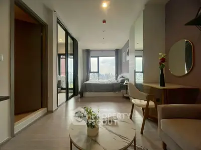 Modern studio apartment with city view, featuring stylish decor and open layout for comfortable living.