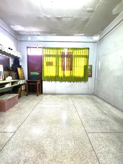 Spacious room with bright yellow curtains and ample natural light, perfect for customization.