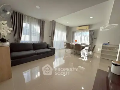 Spacious modern living room with elegant dining area and natural light
