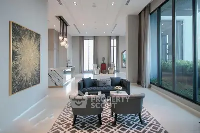 Luxurious modern living room with elegant decor and large windows offering garden views.