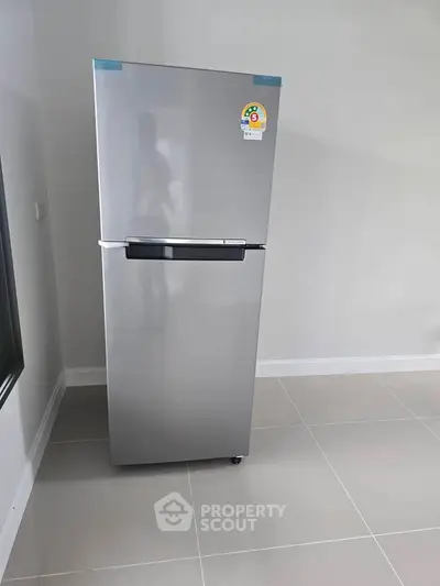 Modern stainless steel refrigerator in a sleek kitchen corner, perfect for contemporary homes.