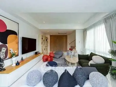 Spacious modern living room with stylish decor and ample natural light.