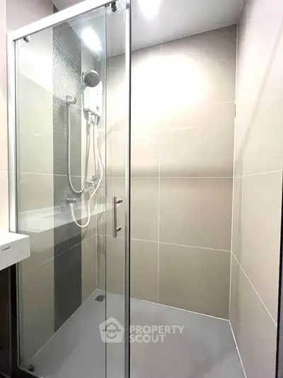 Modern bathroom with glass shower enclosure and sleek tile design