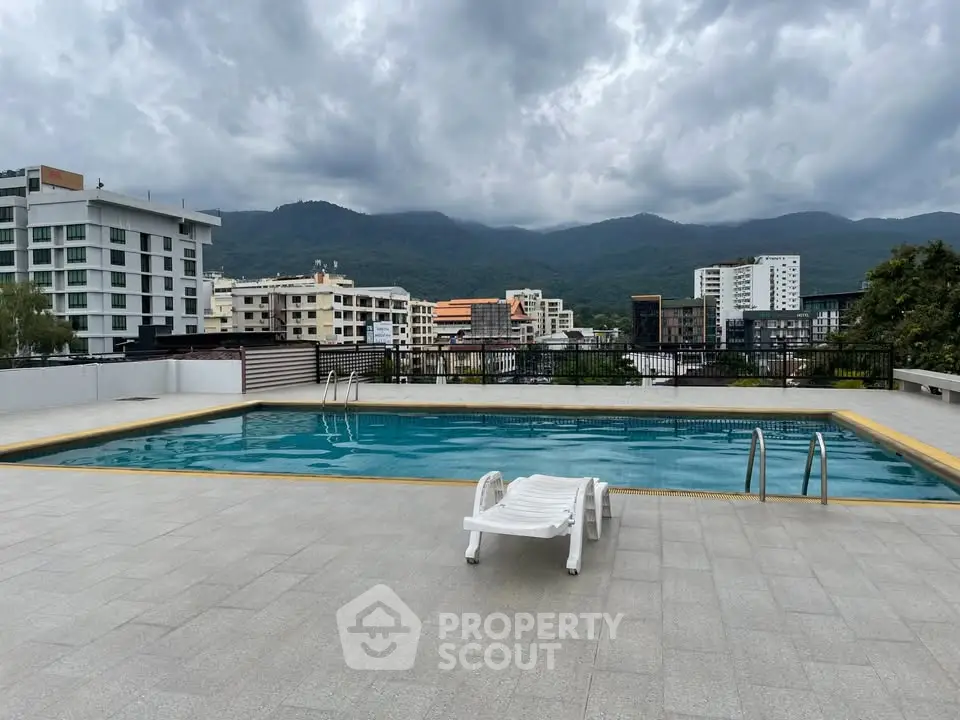 Stunning rooftop pool with mountain views in modern urban setting.