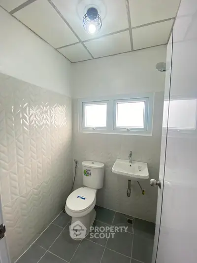Modern bathroom with sleek tile design and compact fixtures