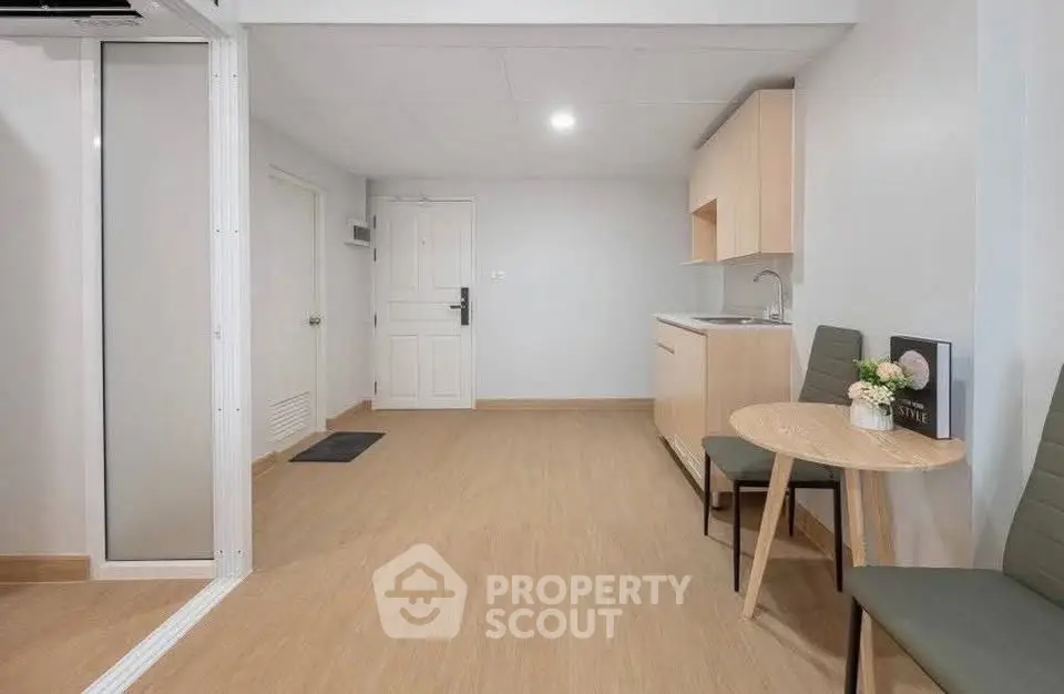 Modern minimalist apartment interior with kitchenette and dining area