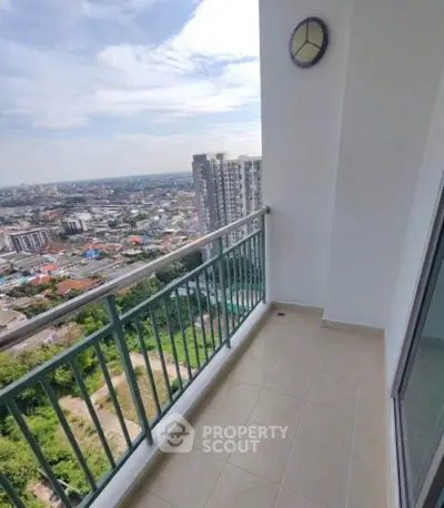 Spacious balcony with stunning city view in modern high-rise apartment.