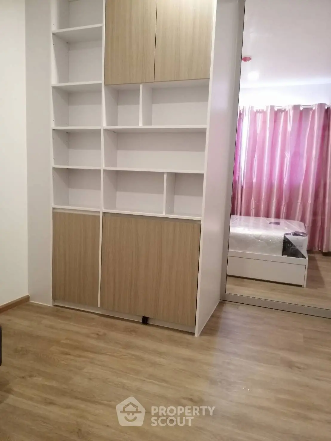 Modern bedroom with built-in storage and mirrored closet doors