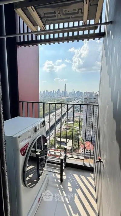High-rise balcony with washing machine and stunning city skyline view