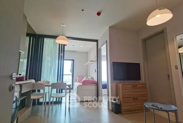 Modern apartment interior with open living area and bedroom view