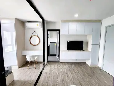 Modern living room with sleek design, featuring wooden flooring, wall-mounted TV, and stylish furniture.