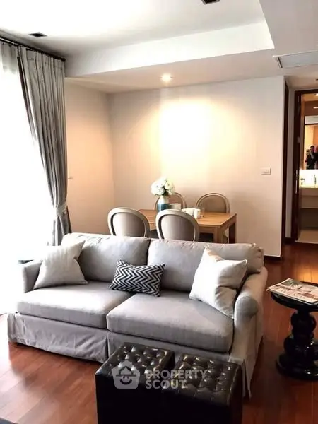 Chic living room with elegant dining area and plush sofa in modern apartment
