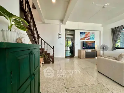 Spacious living room with modern decor and natural light