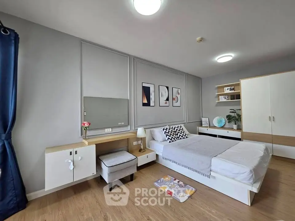 Modern bedroom with stylish decor, featuring a cozy bed, elegant furniture, and contemporary wall art.