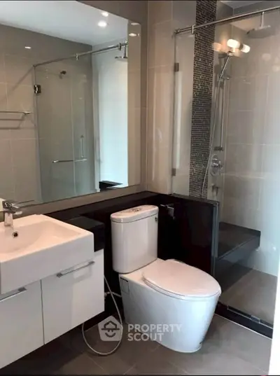 Modern bathroom with sleek fixtures and glass shower enclosure