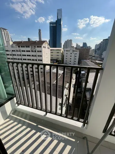 Stunning cityscape view from a modern balcony with sleek railing design.