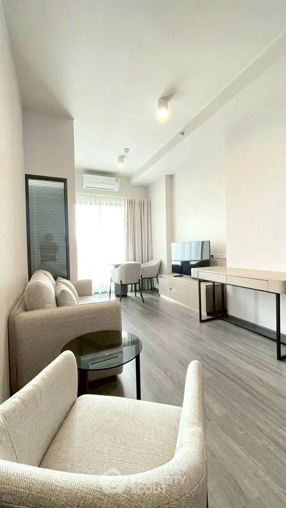 Spacious modern living room with sleek furniture and natural light