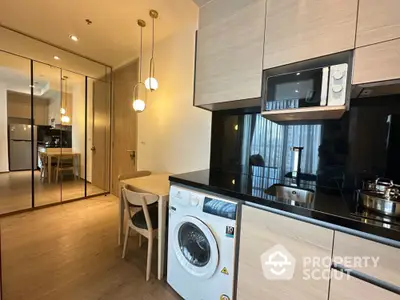 Modern kitchen with washing machine and sleek wooden cabinetry