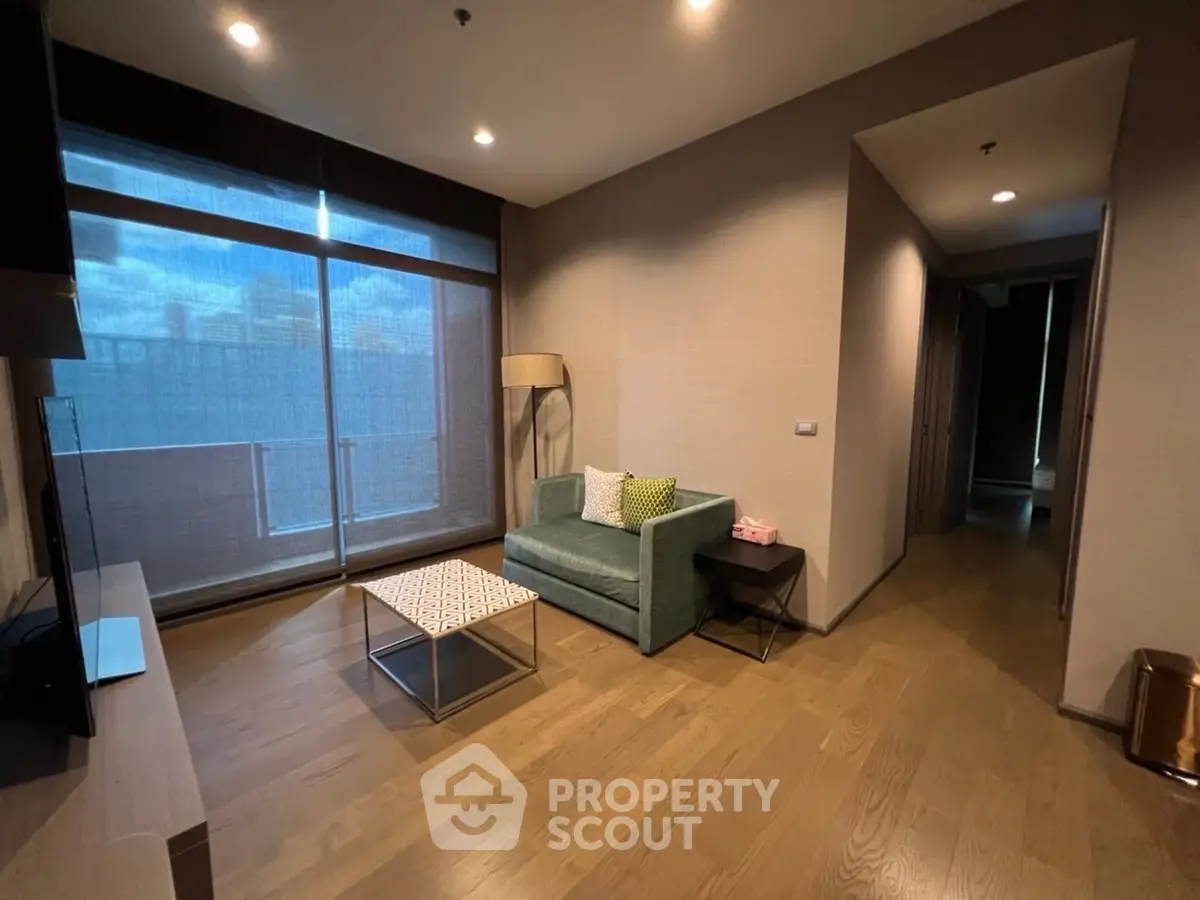 Modern living room with cozy sofa and large window offering natural light.