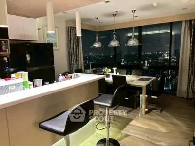 Luxurious modern kitchen with stunning city view, featuring sleek design and elegant lighting.