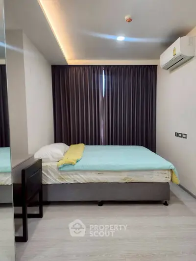Modern bedroom with cozy bed and elegant curtains in a stylish apartment.