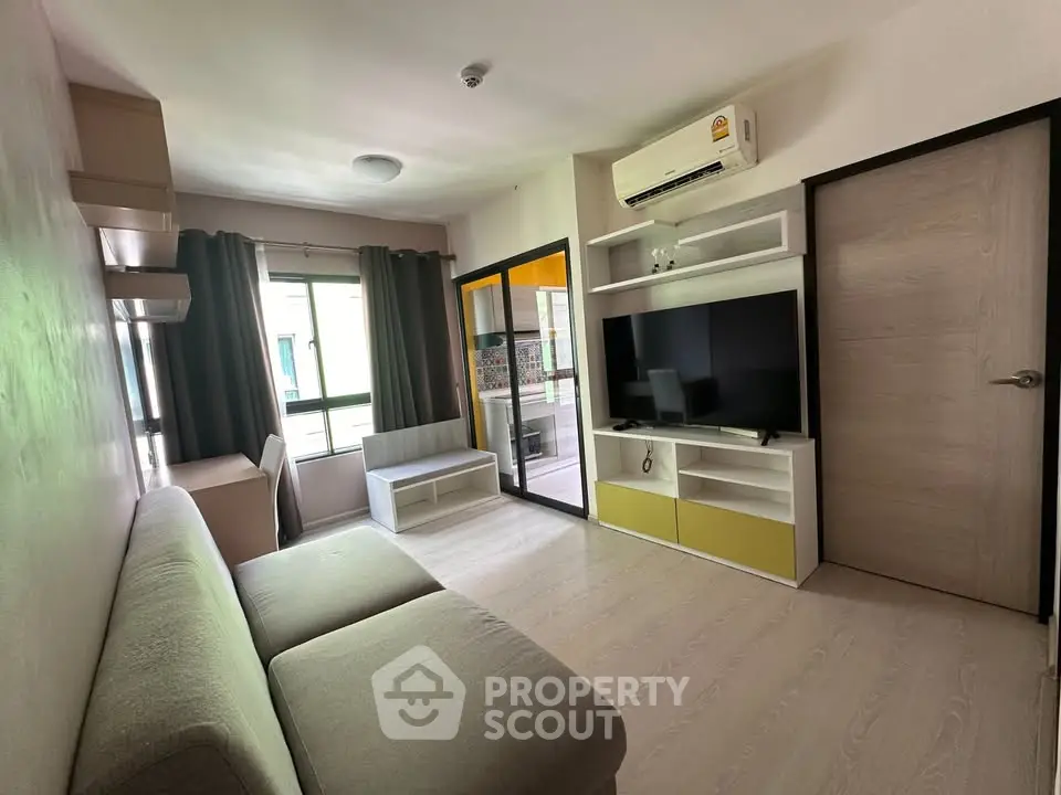 Modern living room with sleek furniture and large window for natural light