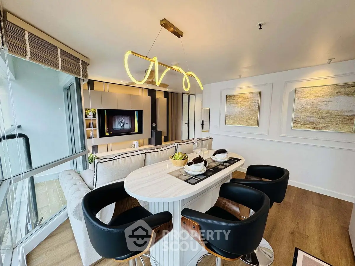 Modern living room with stylish lighting and open layout, featuring a cozy seating area and elegant decor.