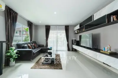 Spacious modern living room with sleek design and large windows for natural light.