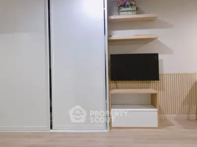 Modern living room with sleek sliding doors and mounted TV