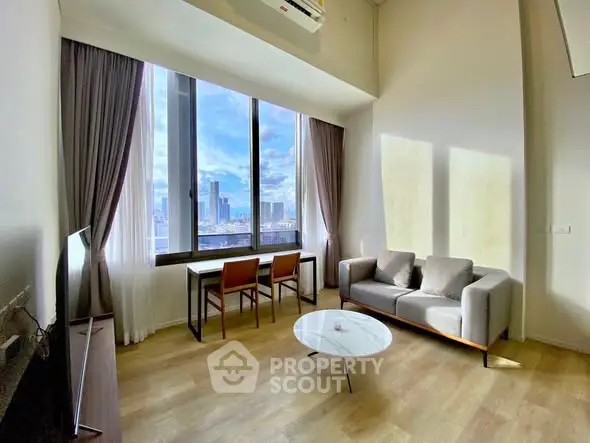 Modern living room with city view, featuring sleek furniture and large windows.