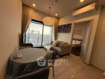 Modern living room with city view and cozy bedroom access