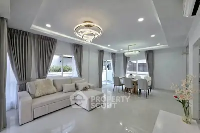 Luxurious modern living room with elegant chandelier and spacious dining area