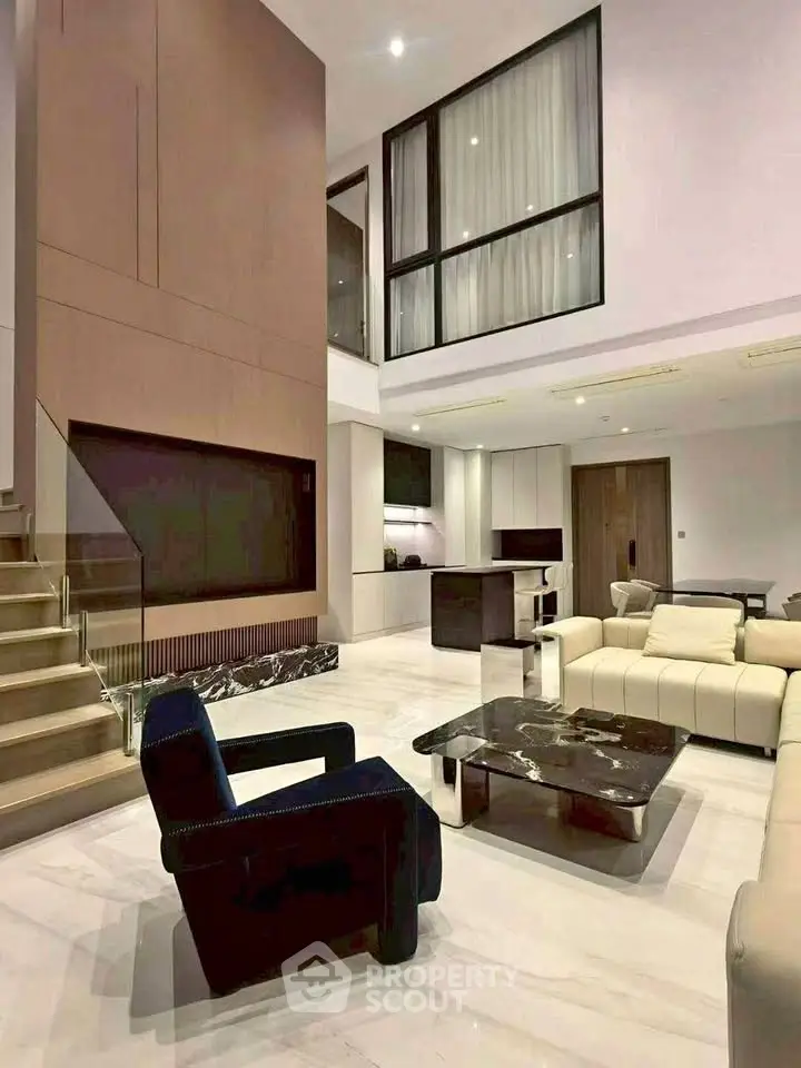 Luxurious modern living room with high ceilings and elegant furniture in a spacious open layout.