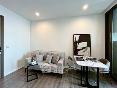 Modern living room with stylish decor and dining area in a contemporary apartment.