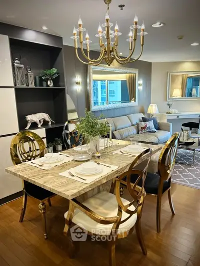 Luxurious dining and living area with elegant chandelier and stylish decor