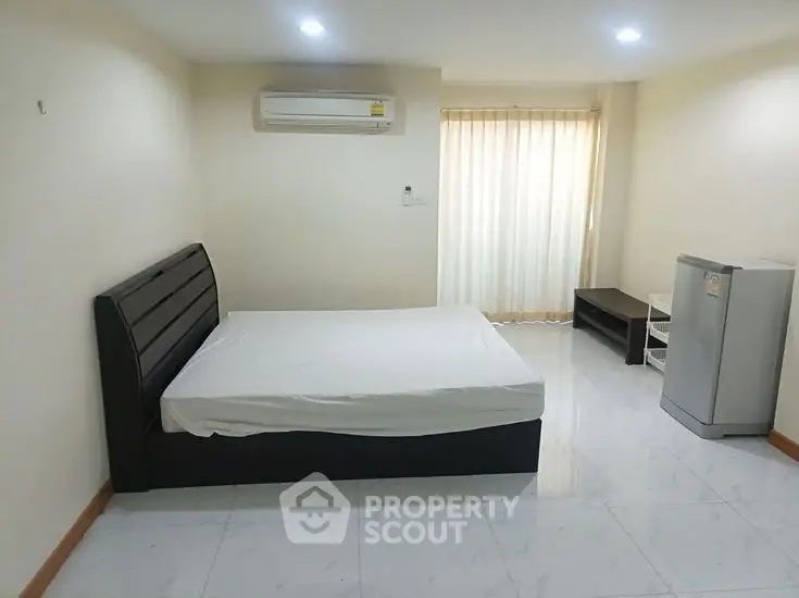 Spacious bedroom with modern bed and air conditioning in a bright apartment