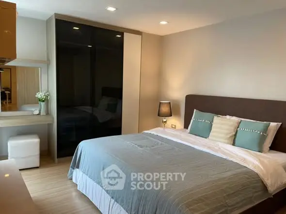 Modern bedroom with stylish decor and cozy ambiance in a real estate property.